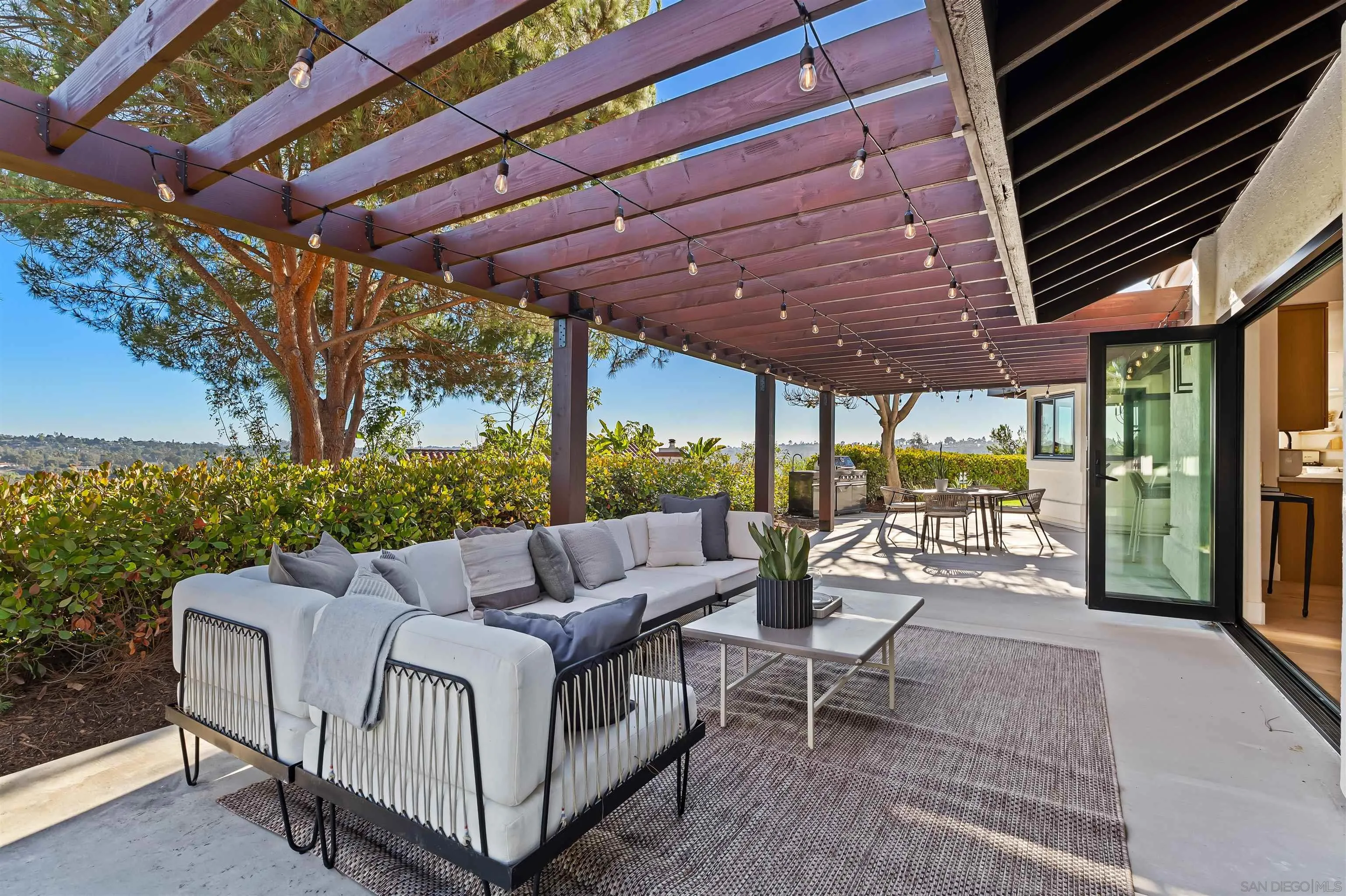 1170 Rancho Encinitas Drive Encinitas, CA 92024 - Photo 27 of 72 a view of a patio with a table and chairs under a umbrella