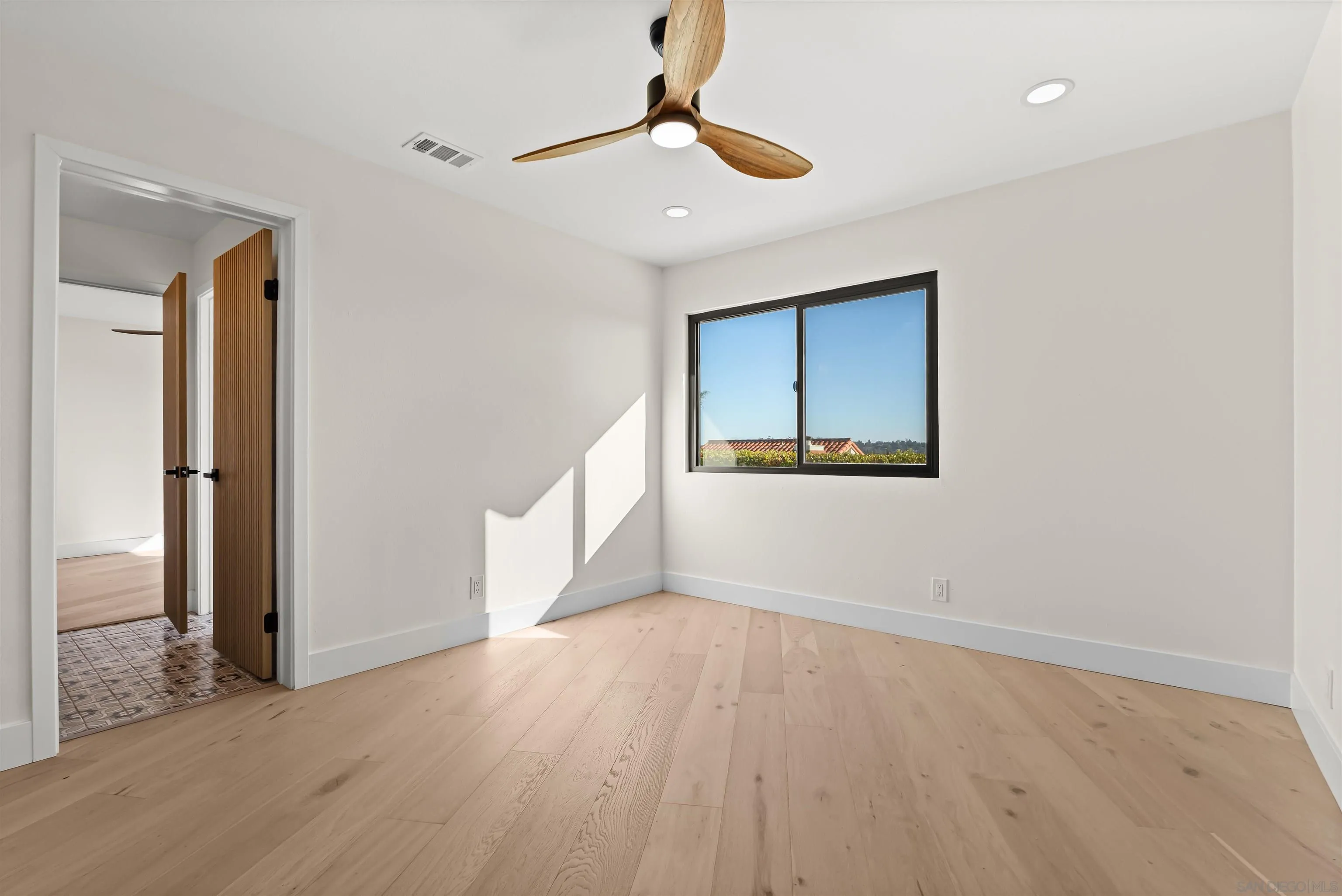 1170 Rancho Encinitas Drive Encinitas, CA 92024 - Photo 45 of 72 a view of an empty room with wooden floor and a window