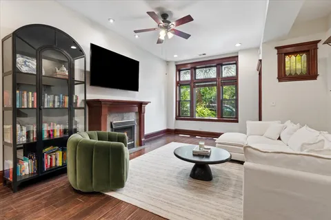 a living room with furniture a fireplace and a flat screen tv
