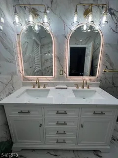 a bathroom with a double vanity sink and a mirror