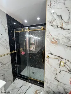 a bathroom with a glass shower door