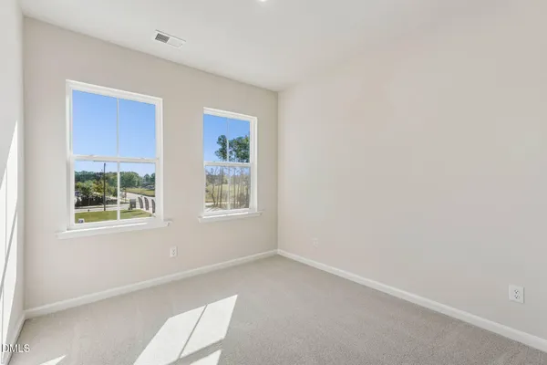 a kitchen with stainless steel appliances white cabinets and a window