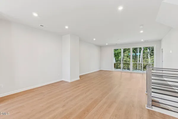 a picture of a room with a white wall and a large window