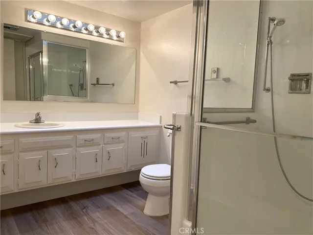 a spacious bathroom with a granite countertop sink mirror and toilet