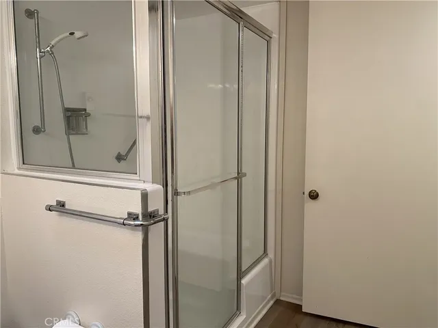 a bathroom with a glass shower door