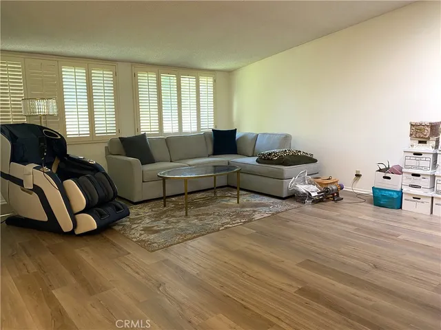 a living room with furniture ceiling fan and a window