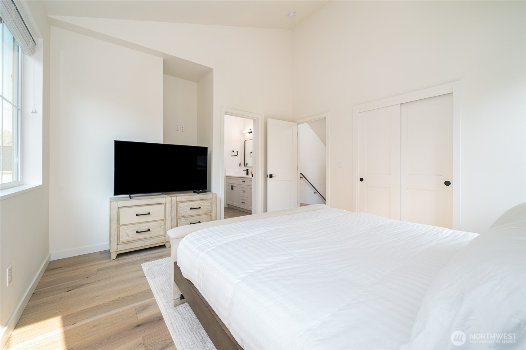 259 Bobcat Lane Chelan, WA 98816 - Photo 23 of 40 a large white bed in a white room with flat screen tv