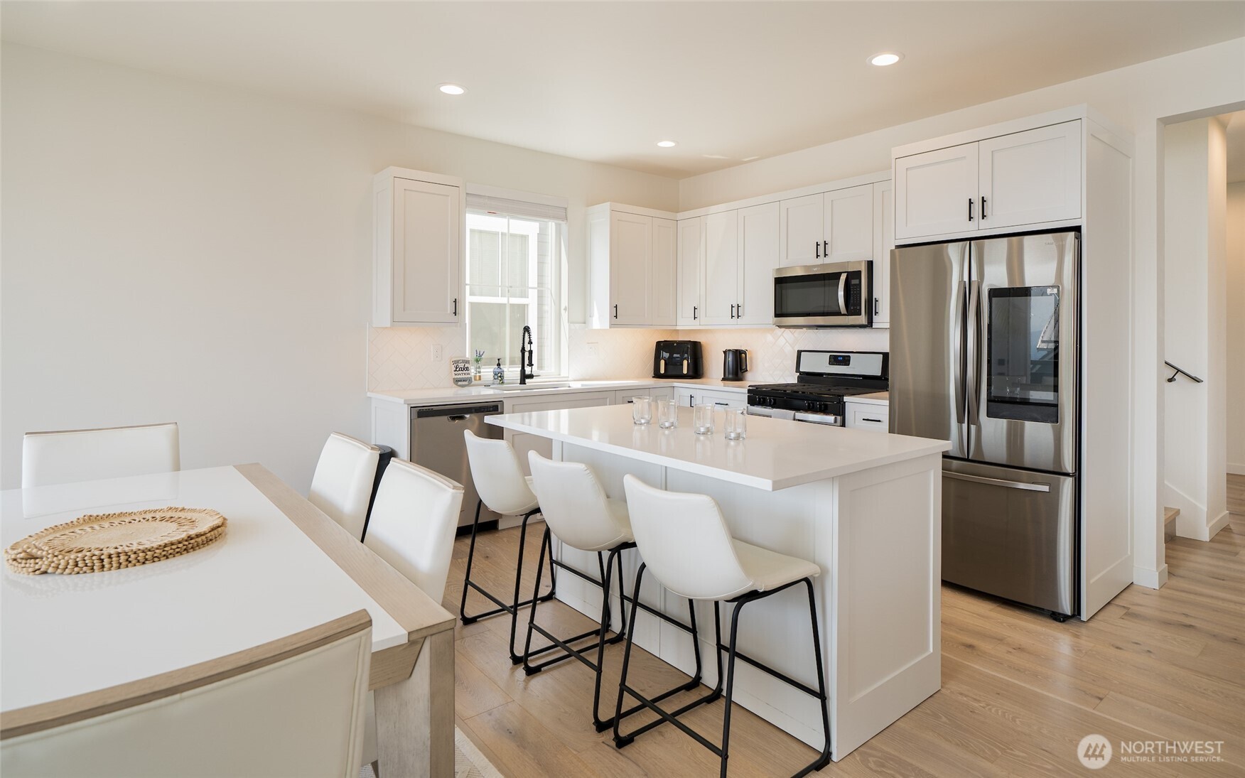 259 Bobcat Lane Chelan, WA 98816 - Photo 8 of 40 a kitchen with stainless steel appliances a refrigerator stove microwave and white cabinets