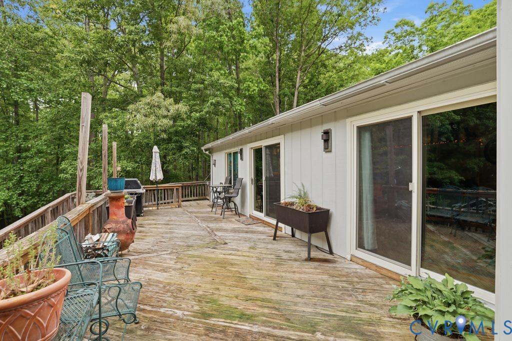 1061 Turkey Ridge Drive Moseley, VA 23120 - Photo 30 of 51 a view of a patio with a dining table and chairs with wooden floor