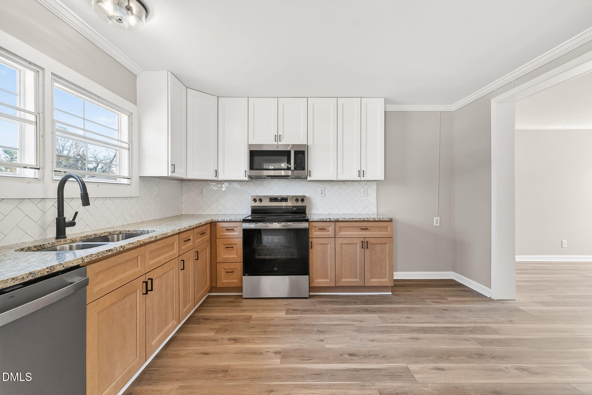 10015 Smith Road Middlesex, NC 27557 - Photo 20 of 48 a kitchen with granite countertop white cabinets and stainless steel appliances