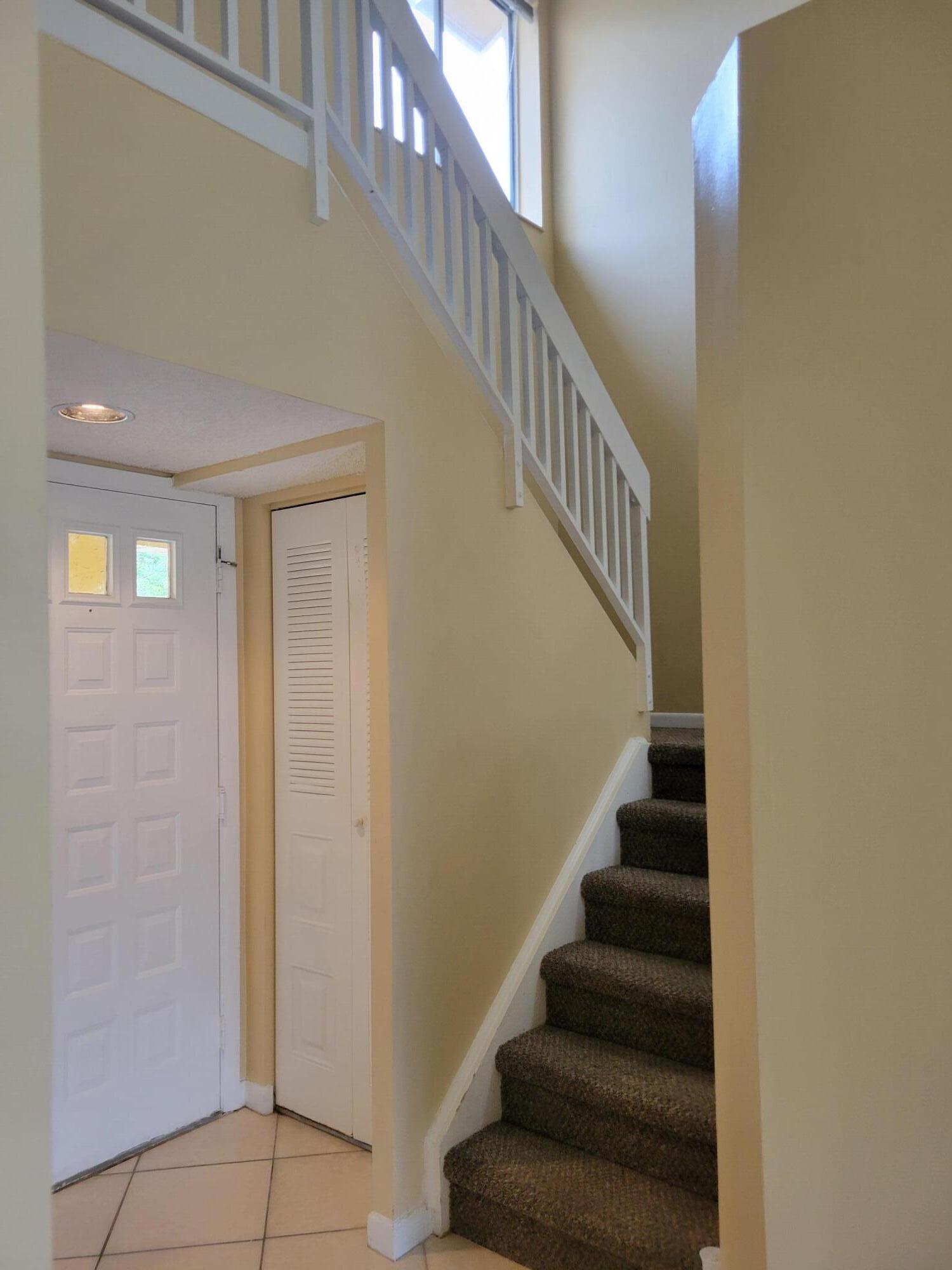 1112 Coral Club Drive, Unit 1112 Coral Springs, FL 33071 - Photo 11 of 16 a view of entryway and hall with wooden floor