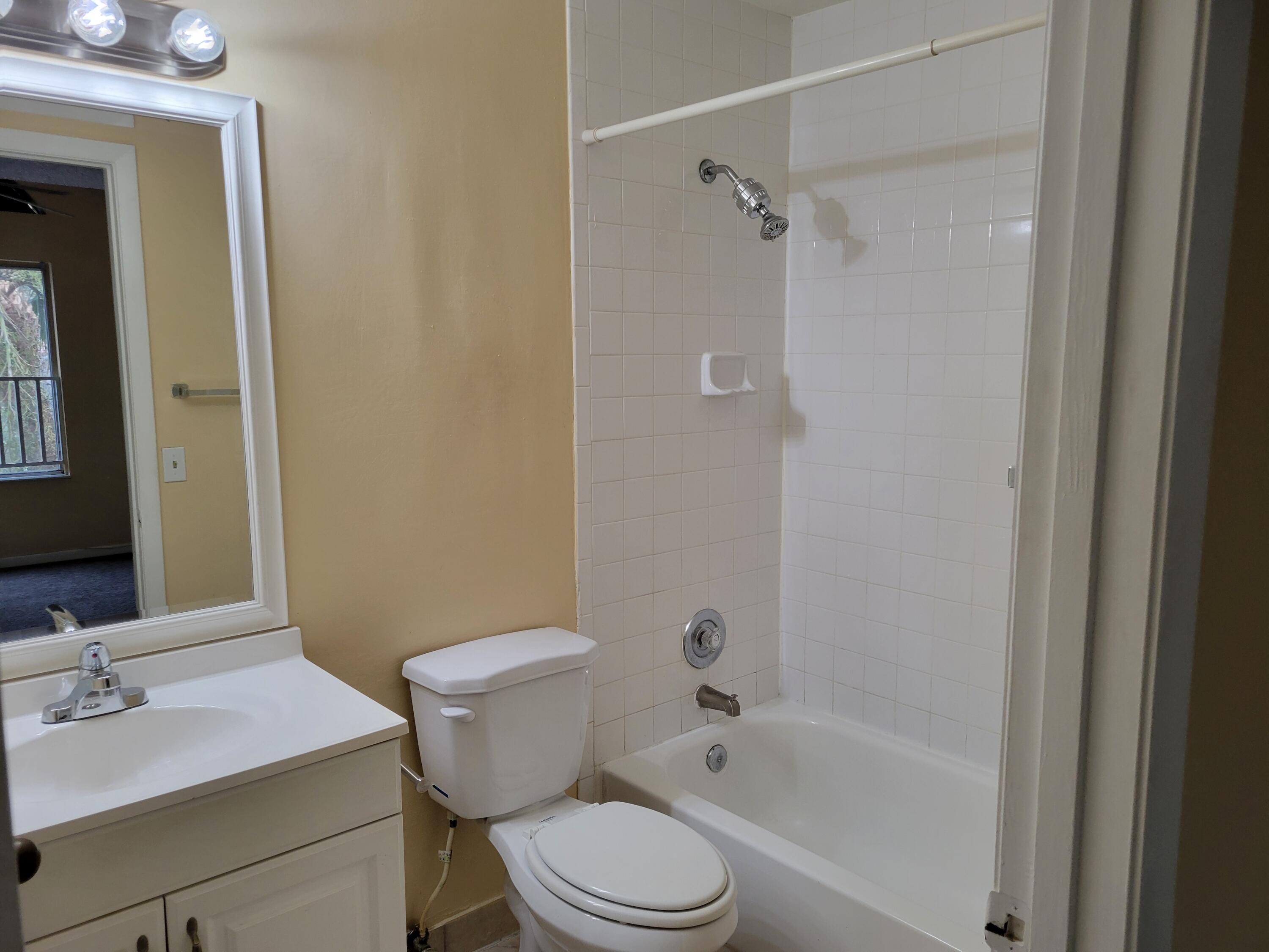 1112 Coral Club Drive, Unit 1112 Coral Springs, FL 33071 - Photo 15 of 16 a bathroom with a sink toilet vanity and shower