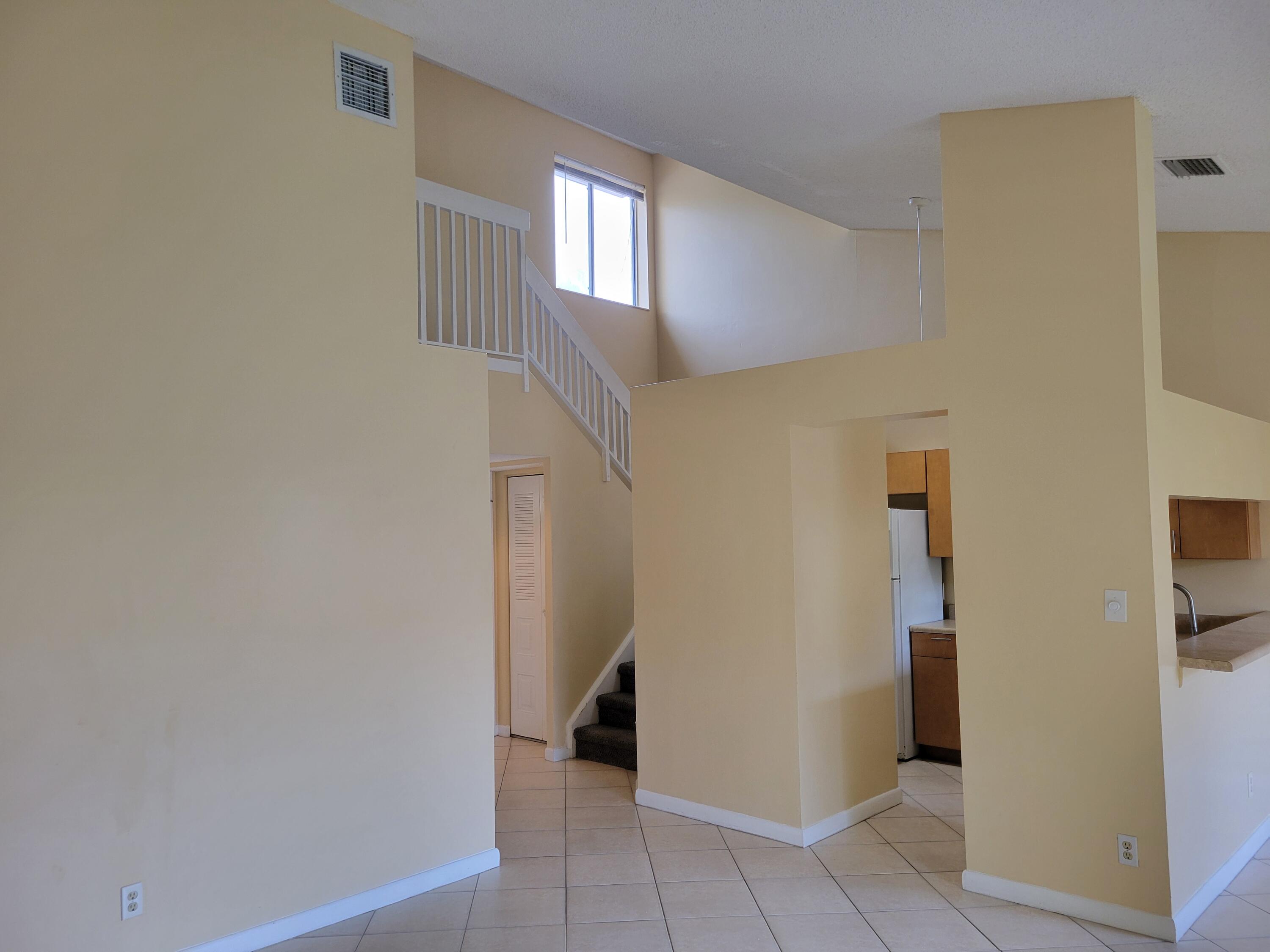 1112 Coral Club Drive, Unit 1112 Coral Springs, FL 33071 - Photo 2 of 16 a view of a hallway with windows and closet