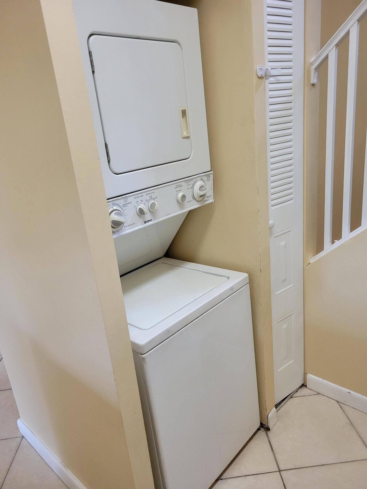 1112 Coral Club Drive, Unit 1112 Coral Springs, FL 33071 - Photo 7 of 16 a utility room with dryer and washer
