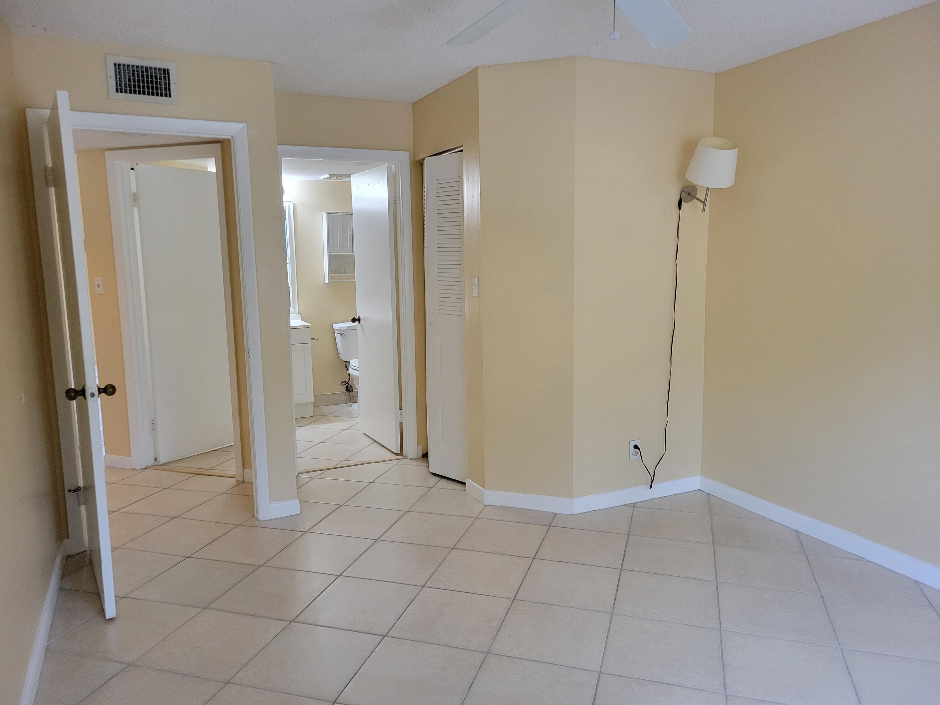 1112 Coral Club Drive, Unit 1112 Coral Springs, FL 33071 - Photo 9 of 16 a view of a bathroom with a shower and a sink