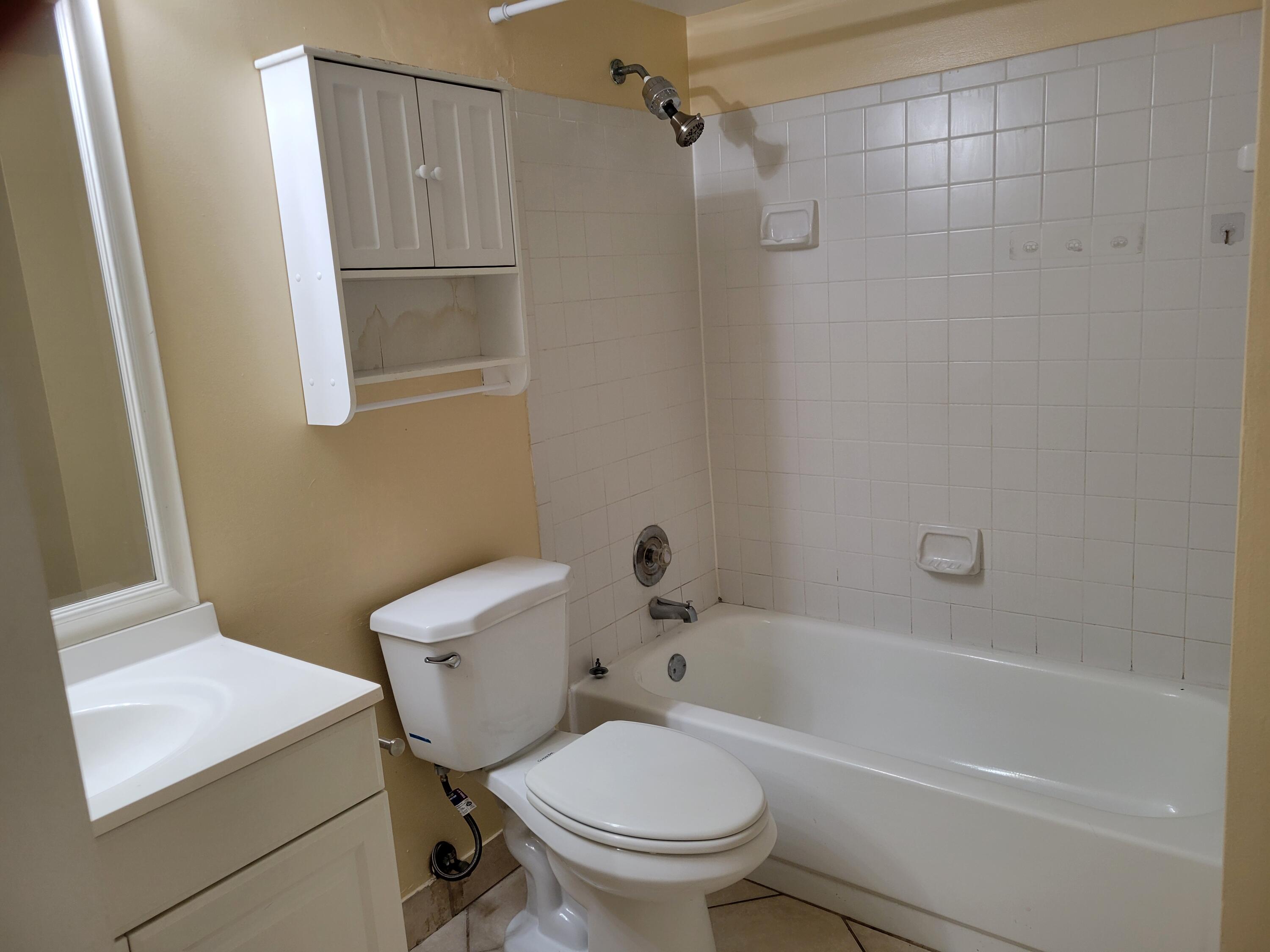 1112 Coral Club Drive, Unit 1112 Coral Springs, FL 33071 - Photo 10 of 16 a white toilet sitting next to a bath tub