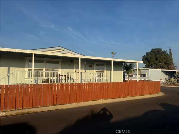 a view of a house with wooden floor and a yard