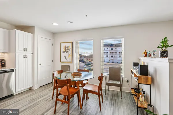 a dining room with furniture and wooden floor