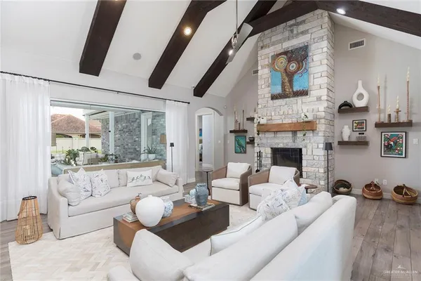 a living room with furniture fireplace and a large window