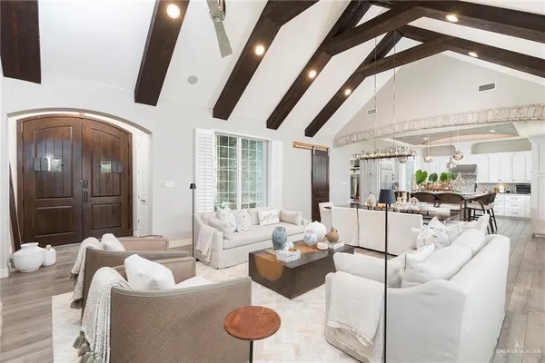 a living room with furniture and wooden floor