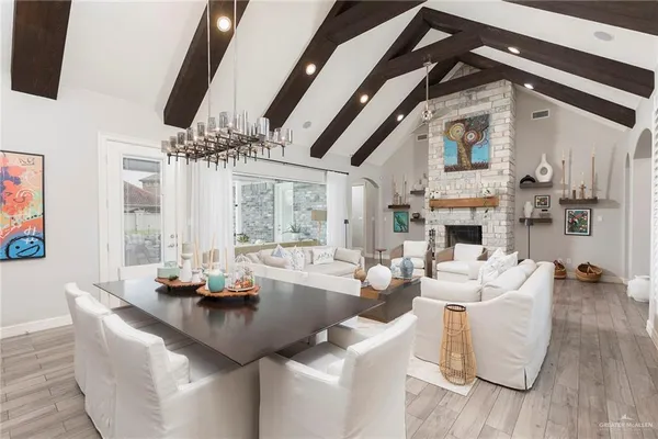 a living room with fireplace furniture and a floor to ceiling window