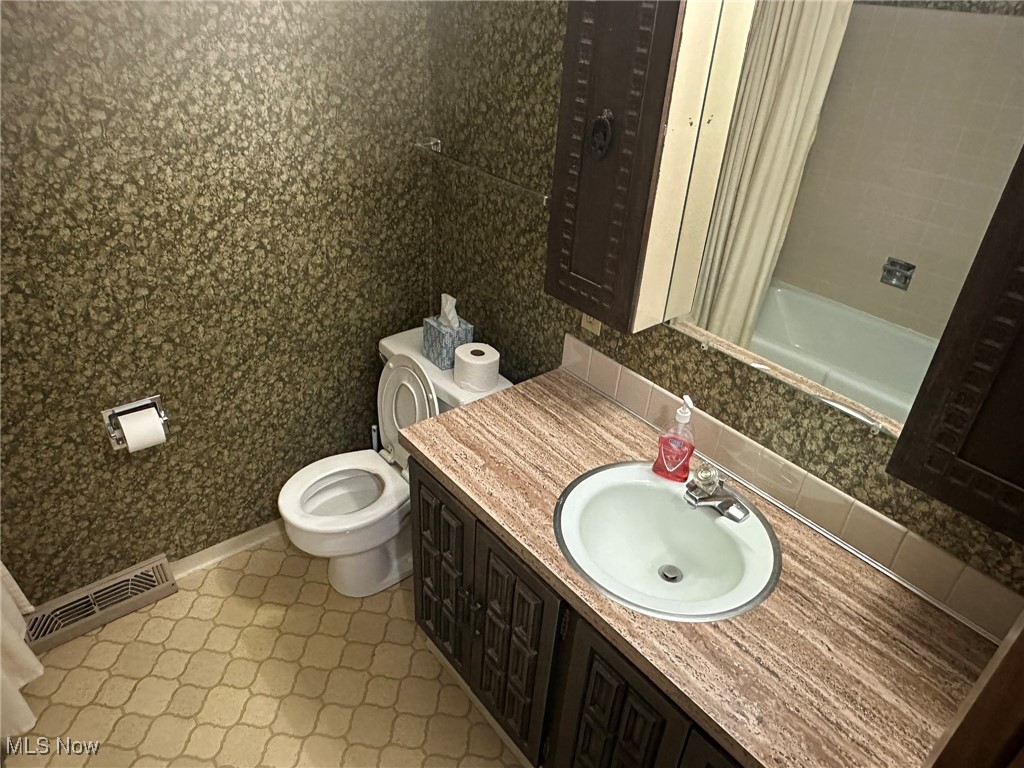 97 West Howe Road Tallmadge, OH 44278 - Photo 25 of 35 Full bathroom with vanity, shower / bath combo with shower curtain, and toilet