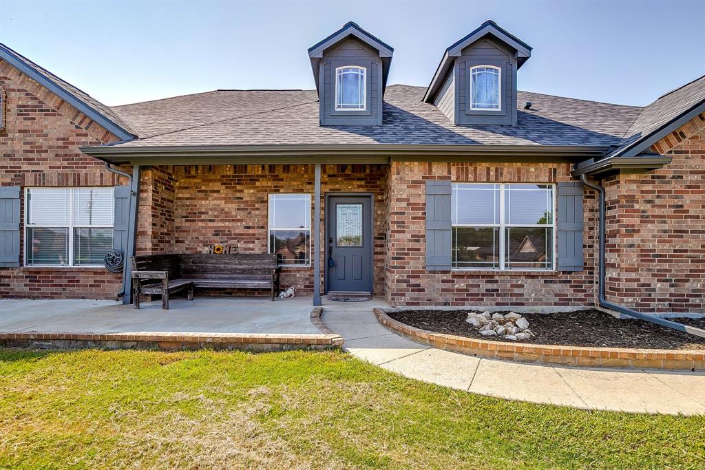 209 Cooperstown Drive Springtown, TX 76082 - Photo 2 of 40 Property entrance featuring brick siding, a porch, and a yard
