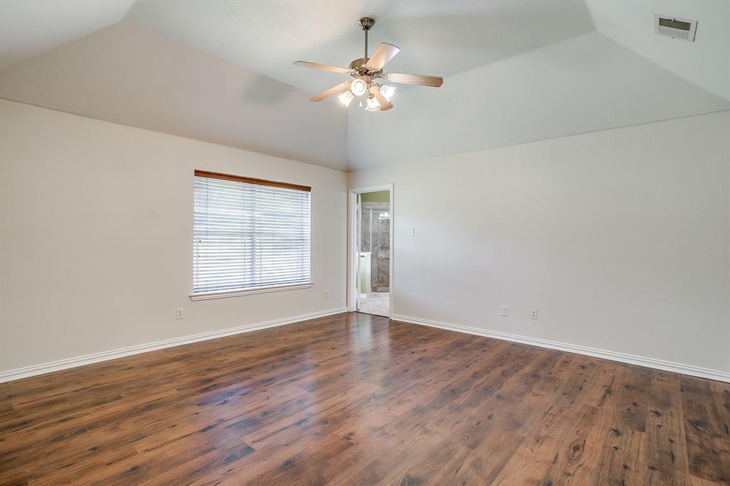 209 Cooperstown Drive Springtown, TX 76082 - Photo 21 of 40 Unfurnished room with dark wood-type flooring, lofted ceiling, and ceiling fan