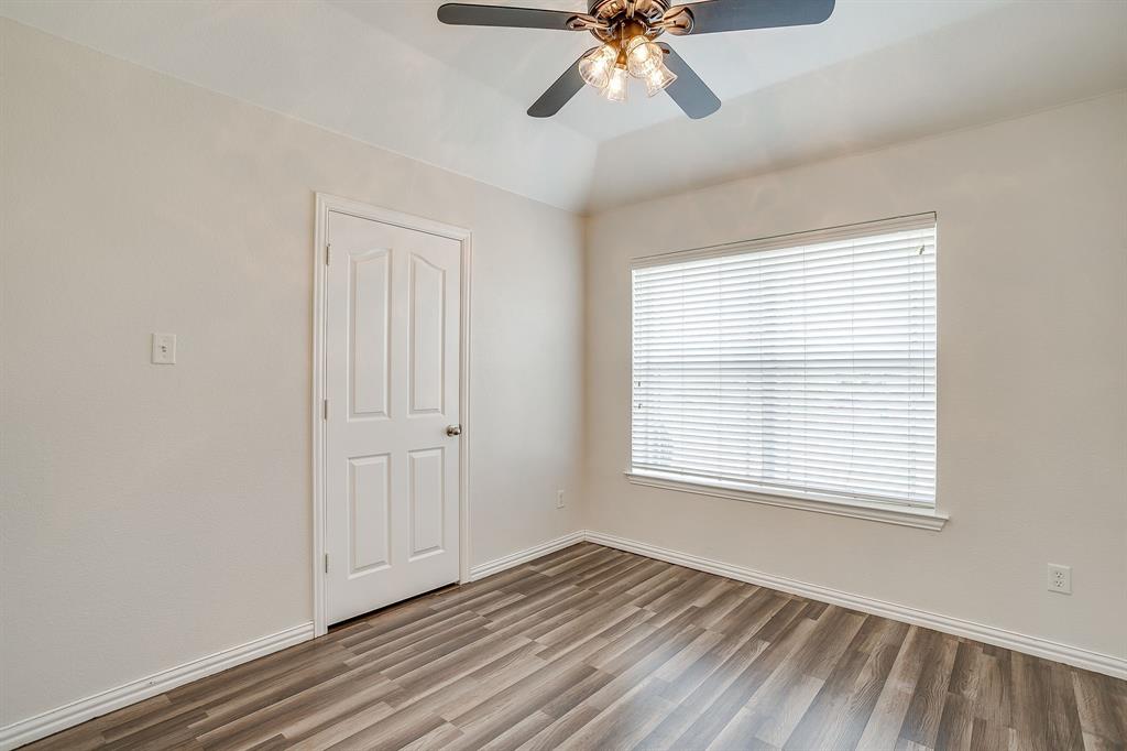 209 Cooperstown Drive Springtown, TX 76082 - Photo 26 of 40 Unfurnished bedroom featuring wood finished floors and ceiling fan