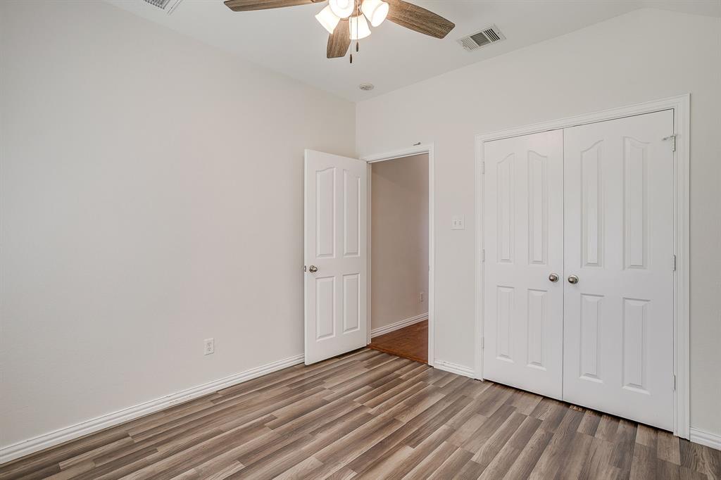 209 Cooperstown Drive Springtown, TX 76082 - Photo 28 of 40 Unfurnished bedroom featuring light wood-type flooring, a closet, and ceiling fan