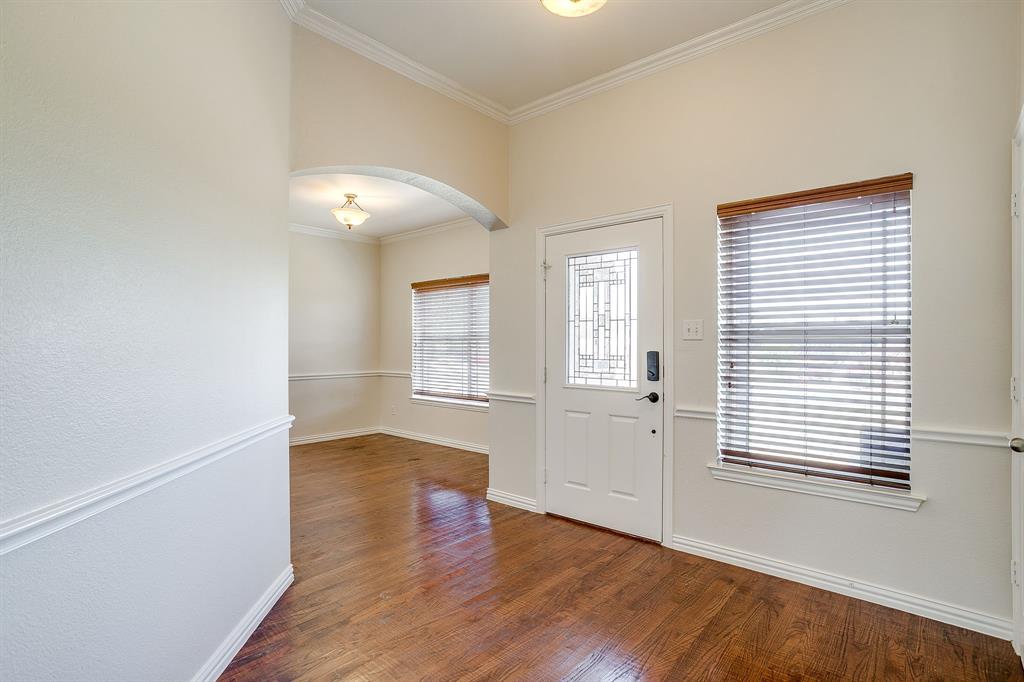 209 Cooperstown Drive Springtown, TX 76082 - Photo 3 of 40 Foyer entrance featuring ornamental molding, arched walkways, and wood finished floors