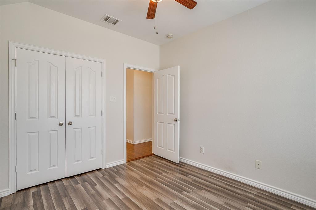 209 Cooperstown Drive Springtown, TX 76082 - Photo 30 of 40 Unfurnished bedroom with wood finished floors, a closet, and a ceiling fan