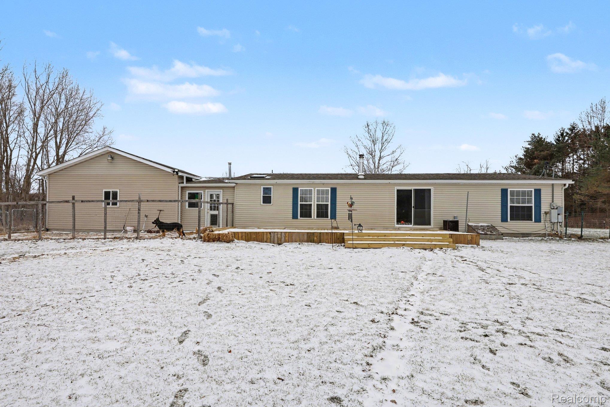 4458 Palms Road Casco, MI 48064 - Photo 2 of 32 Snow covered rear of property with a deck