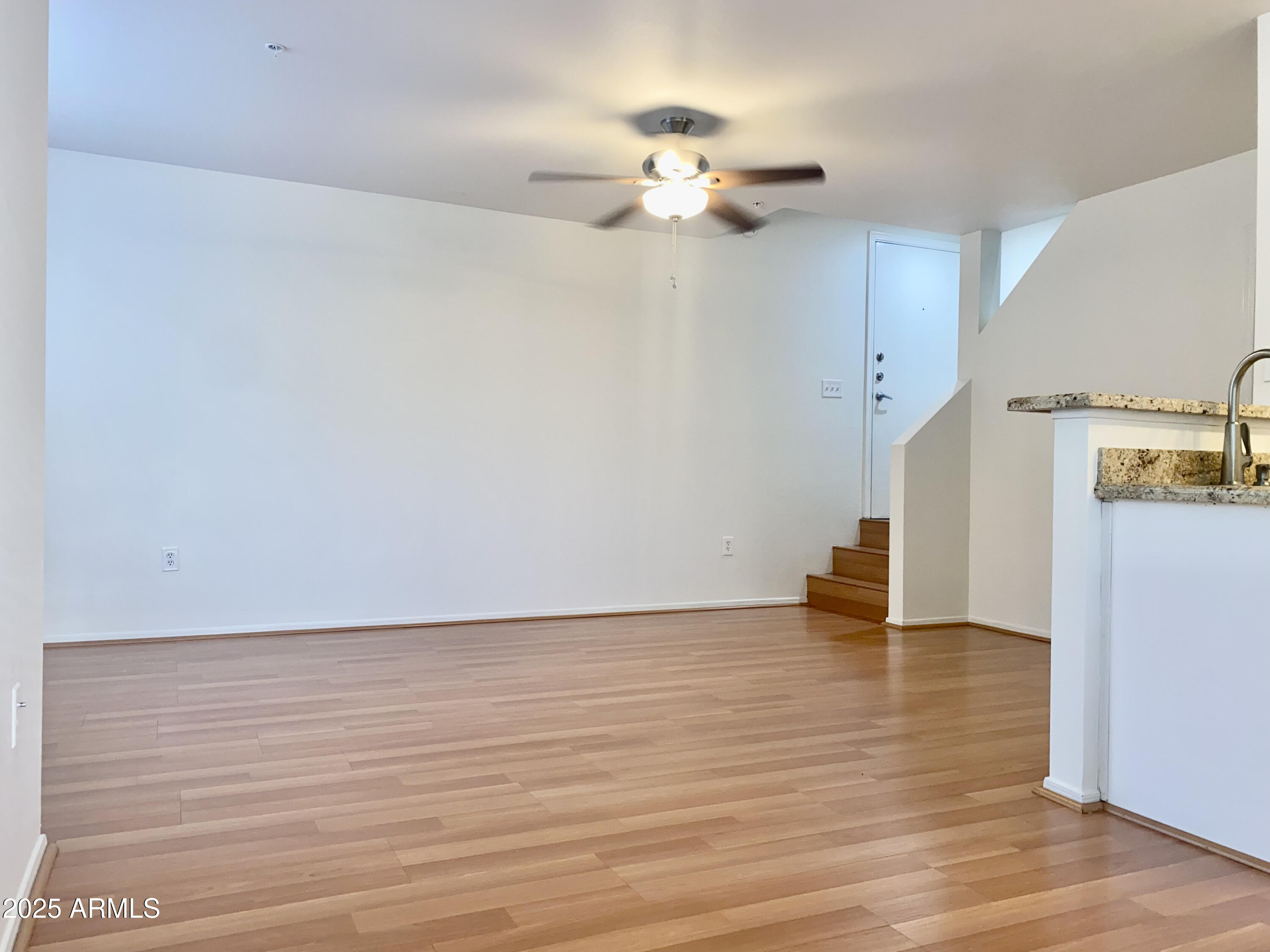 1701 East Colter Street, Unit 1 Phoenix, AZ 85016 - Photo 3 of 17 a view of an empty room with wooden floor
