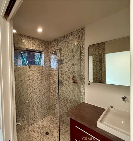 a bathroom with a shower and a sink