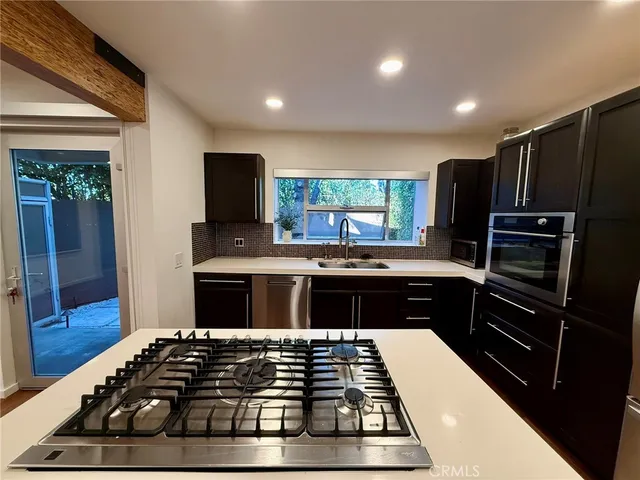 a kitchen with a large stove a sink and a refrigerator