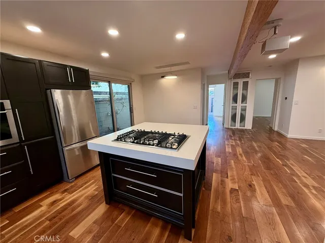 a kitchen with a stove a refrigerator and a sink
