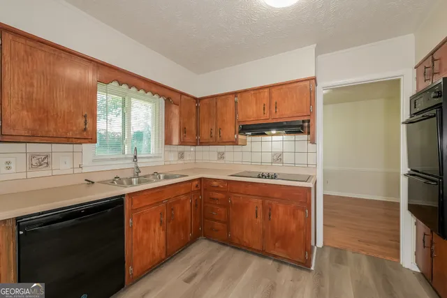 a kitchen with a sink stove and refrigerator