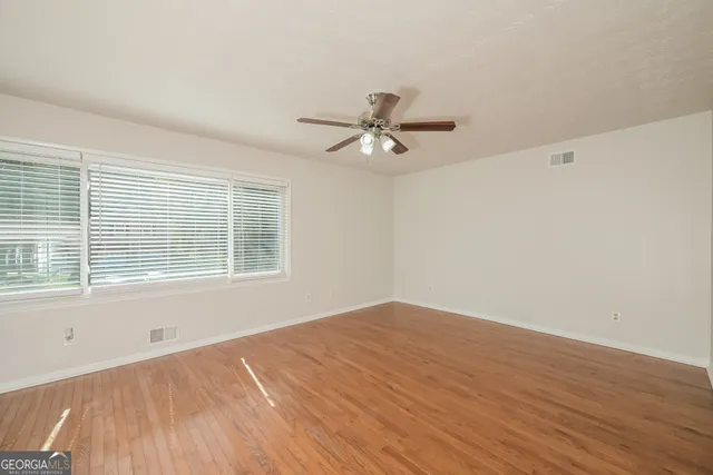 wooden floor in an empty room with a window
