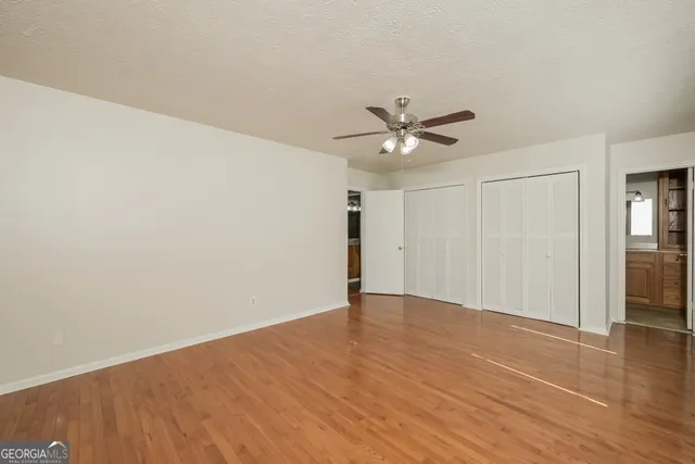 a view of an empty room with wooden floor