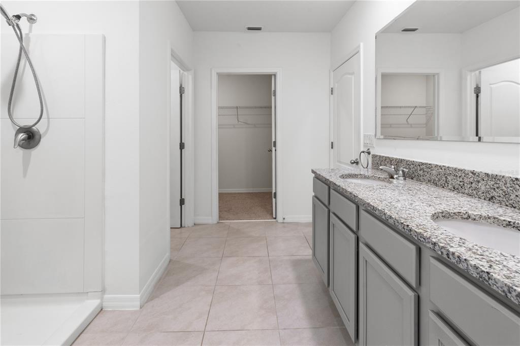 2651 Grandbury Grove Road Lakeland, FL 33811 - Photo 21 of 41 a bathroom with a granite countertop sink and a mirror