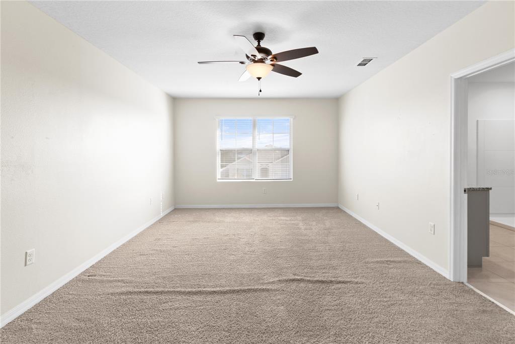 2651 Grandbury Grove Road Lakeland, FL 33811 - Photo 25 of 41 an empty room with a window and a ceiling fan