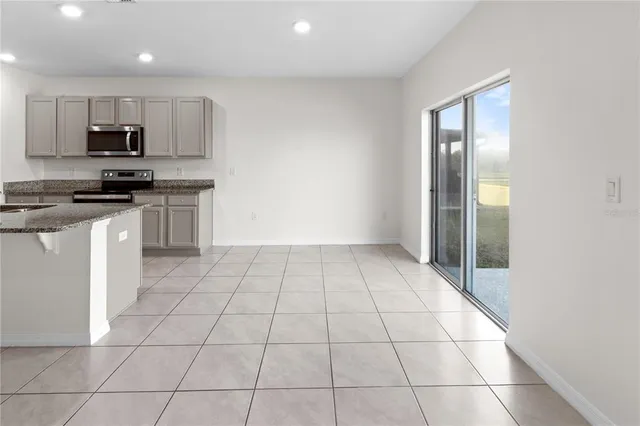 a kitchen with stainless steel appliances a sink a stove a microwave and cabinets