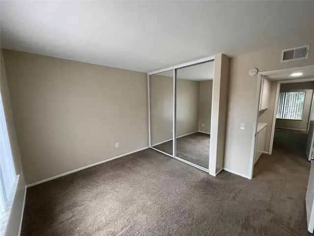 a view of an empty room and closet area