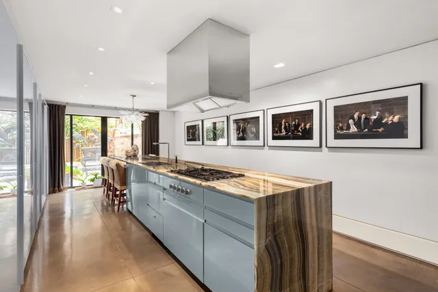 a living room with furniture large window and fireplace