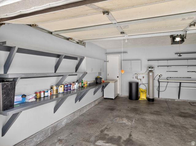 802 Sugar Maple Court Payson, UT 84651 - Photo 22 of 30 Garage with white fridge and a garage door opener