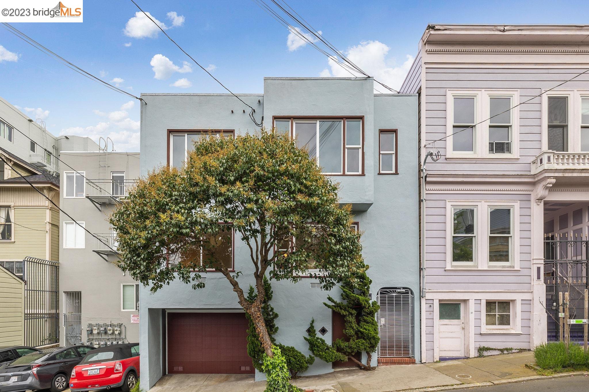 279 Rose Street San Francisco, CA 94102 - Photo 1 of 50 a front view of a building with a garden and plants