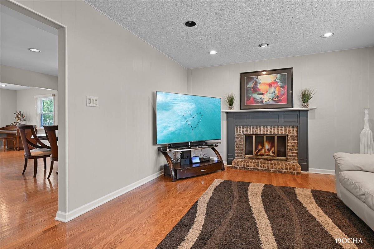 165 Stonegate Road Buffalo Grove, IL 60089 - Photo 12 of 25 a living room with furniture a flat screen tv and a fireplace