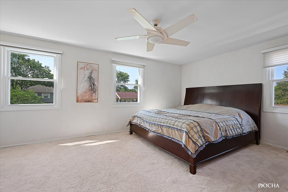 165 Stonegate Road Buffalo Grove, IL 60089 - Photo 17 of 25 a bedroom with a bed lamp and window