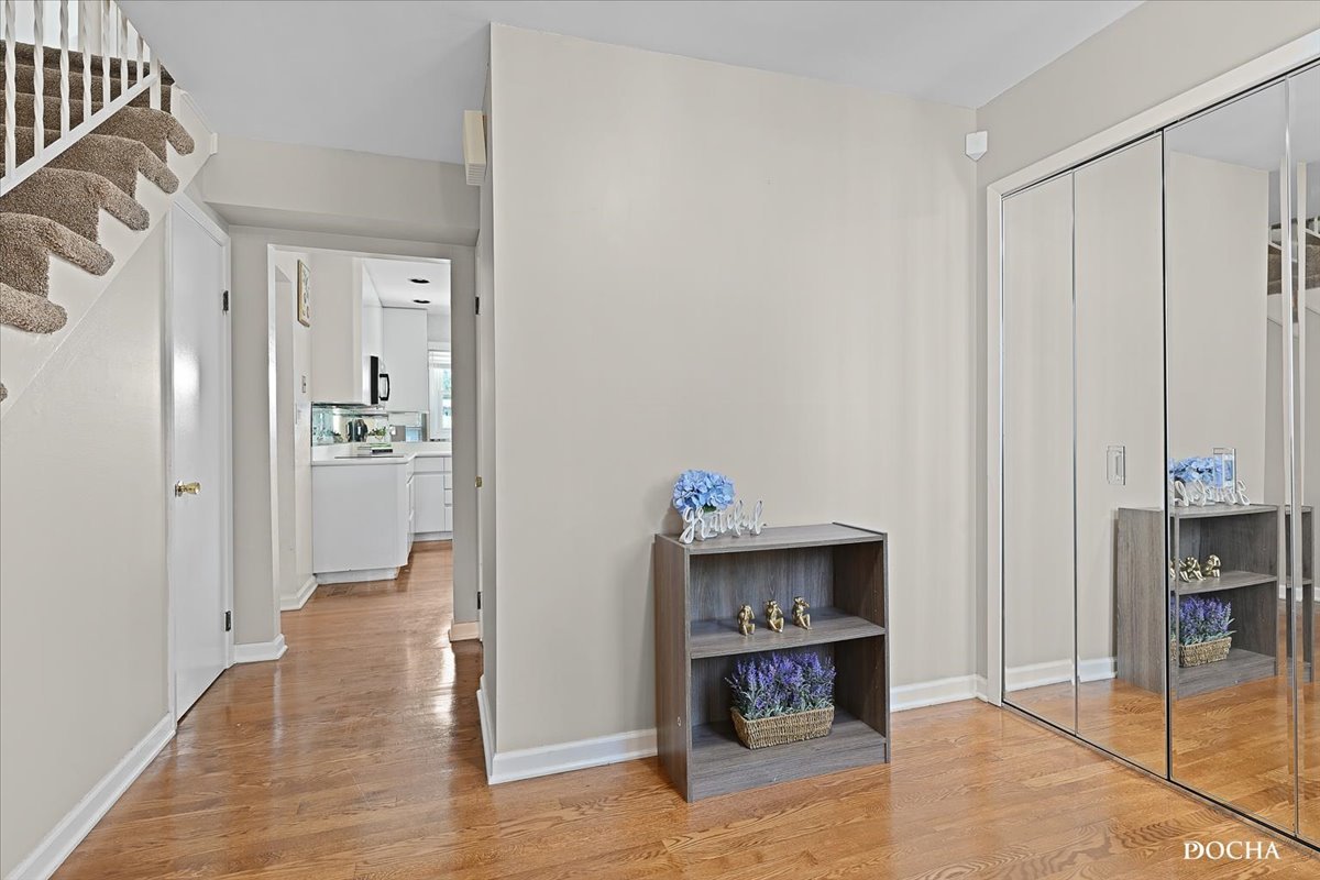165 Stonegate Road Buffalo Grove, IL 60089 - Photo 3 of 25 a view of a hallway with wooden floor and cabinet